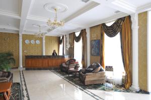 una sala de estar con 2 personas sobre sofás en un edificio en SPA-Hotel Dodo en Zhytomyr