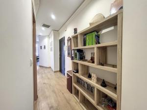 a hallway with wooden shelves with books at My Cosy Flat-Centre of Nice- Perfect location in Nice
