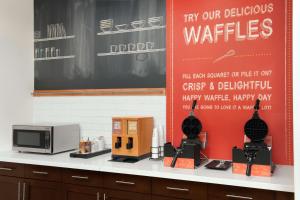 a table with a microwave and a blackboard at Hampton Inn & Suites Orangeburg, SC in Orangeburg