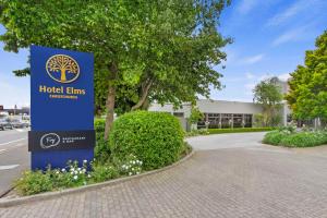 a sign in front of a building at Hotel Elms Christchurch, Ascend Hotel Collection in Christchurch