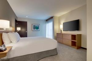 um quarto de hotel com uma cama e uma televisão em Hyatt Place Milwaukee Downtown em Milwaukee