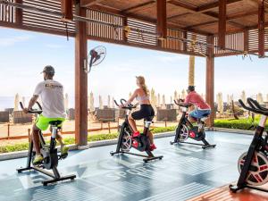 a group of people riding on exercise bikes in a gym at Rixos Premium Seagate - Ultra All Inclusive in Sharm El Sheikh