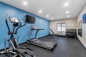 a gym with two exercise bikes and a flat screen tv at Comfort Inn & Suites in Brunswick