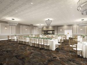 a banquet hall with white tables and chairs at DoubleTree by Hilton Poughkeepsie in Poughkeepsie