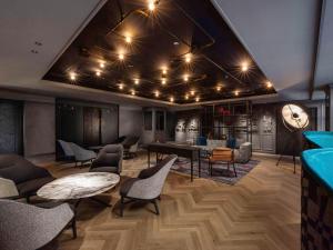 a lobby with tables and chairs and a bar at Mercure Tokyo Haneda Airport in Tokyo