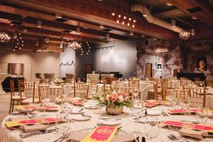 a banquet hall with a table with glasses and flowers at Whitney Peak Hotel Reno, Tapestry Collection by Hilton in Reno