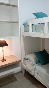 a bedroom with two bunk beds and a table at Duplex Atenea in Chivilcoy