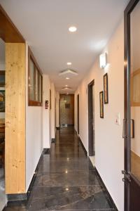 a hallway in a building with a tile floor at Hazelwood in Kandāghāt