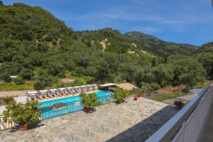 a swimming pool with a view of a mountain at Marina Apartments, Agios Gordios Corfu in Agios Gordios