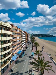 a view of the beach from the balcony of a resort at Almirall Apartaments in Lloret de Mar