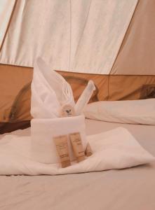 a towel animal sitting on top of a bed at JUSH NATIVE AND GLAMPING in Dauis