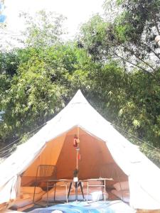 a tent with two chairs and a table at JUSH NATIVE AND GLAMPING in Dauis