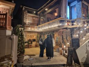 two people standing outside of a building at night at Classic LeeYou in Seoul