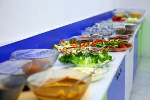 a buffet line with salads and bowls of food at Uğur Otel in Kas