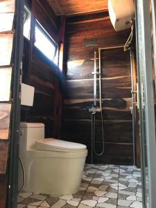 a bathroom with a toilet and a shower at Gỗ Homestay khu sinh thái Akodhong và trung tâm BMT in Buon Ma Thuot