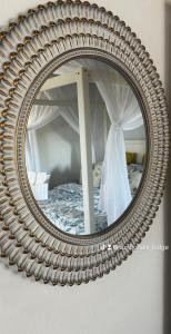 a mirror reflection of a bed in a bedroom at Sunbonani Lodge in Maputo