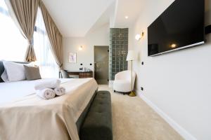1 dormitorio con 1 cama con toallas en Hotel Bohemian Garni - Skadarlija, en Belgrado