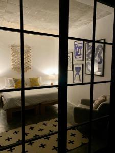 a bedroom with a bed through a glass window at The CIVYT in Ubud