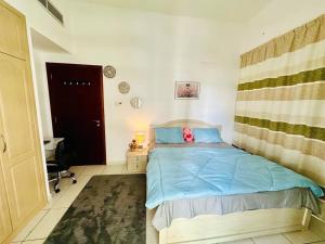 a bedroom with a bed with a stuffed animal on it at Deluxe GIRLS HOSTEL in Dubai