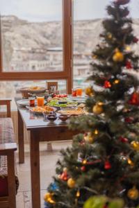 a table with a christmas tree in a room at Zeus Cave Suites in Goreme