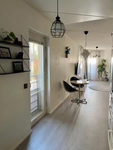 a living room with a table and chairs and a window at Central 2 Br in Tampere