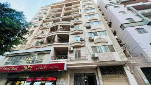 a tall building with balconies on the side of it at Luxurious apartment, 5K Premium Housing! in Az Zaqāzīq