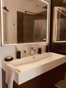 a bathroom with a white sink and a mirror at Casa Roma Montpellier Bed&Breakfast chambres d hôte in Montpellier
