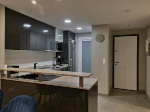 a kitchen with a counter top and a sink at Flamenca Village Penthouse with Private Rooftop and Sea View in Orihuela