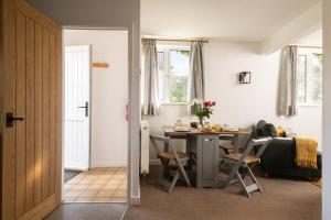 a kitchen and dining room with a table and chairs at Harvest Cottage in Bridlington