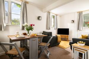 a kitchen and living room with a table and chairs at Harvest Cottage in Bridlington