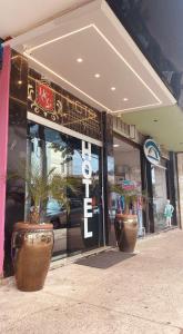 a store front with two potted plants in front of it at Hotel central campo grande in Campo Grande