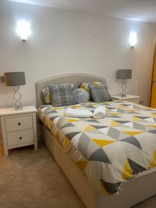 a bed in a bedroom with two night stands and two lamps at Ensuite Room in Royal Victoria Excel O2 Arena London in London