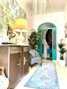 a living room with a blue and green door at Maison B in Bergerac