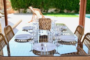 - une table avec des assiettes et des verres à vin dans l'établissement Mediterranean Luxury Villa, à Ialyssos