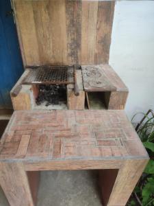 a wooden bench sitting on top of a sidewalk at Pousadinha Ateliê da Maite in Paraty