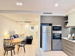 a kitchen and living room with a table and a refrigerator at New Town Studio in Sydney +14 photos