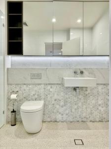 a bathroom with a toilet and a sink at New Town Studio in Sydney