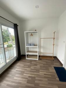 a room with white walls and a large window at Aileen House in Chiang Mai