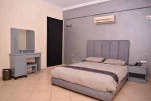 Un ou plusieurs lits dans un hébergement de l'établissement Appart Hôtel Founty Beach