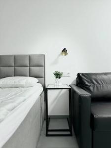 ein Schlafzimmer mit einem Bett und einem Beistelltisch mit einer Lampe in der Unterkunft NEW Modern Large Apartment in New Town 3BDR in Prag