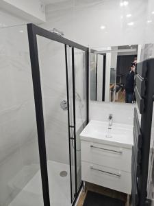 a bathroom with a white sink and a shower at Lovely appartement near sea and Monaco with free parking in Roquebrune-Cap-Martin +59 photos