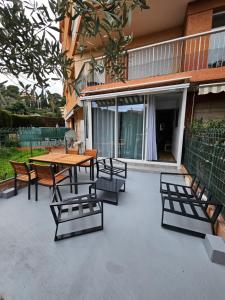 a patio with a wooden table and chairs at Lovely appartement near sea and Monaco with free parking in Roquebrune-Cap-Martin