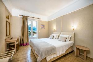 a hotel room with a bed and a window at Malia Mare Hotel in Malia