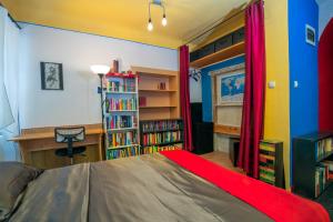 a bedroom with a bed and a book shelf with books at The Book Nest in Ljubljana