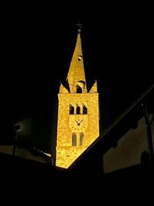 a tower with a clock on it at night at deer house in Savoulx
