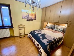 a bedroom with a bed and a chandelier at deer house in Savoulx