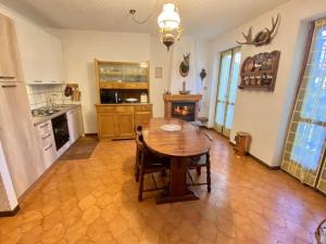 a kitchen with a wooden table in a room at deer house in Savoulx