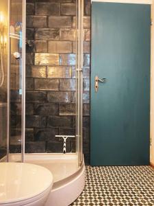 a bathroom with a shower with a toilet and a tub at Haus Anastasia in Stolberg
