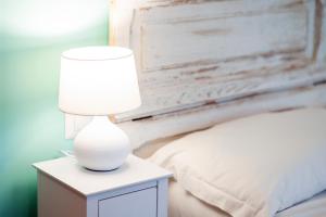 A bed or beds in a room at Palazzo Attila - Gioia Apartments