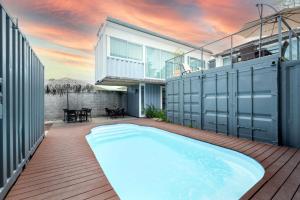 a swimming pool in the backyard of a house at Hotel Bamboo in Jacó